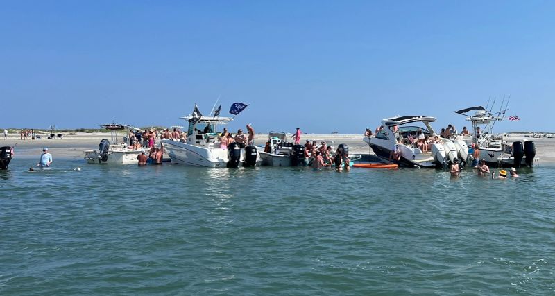 Family swimming at sandbar beach
