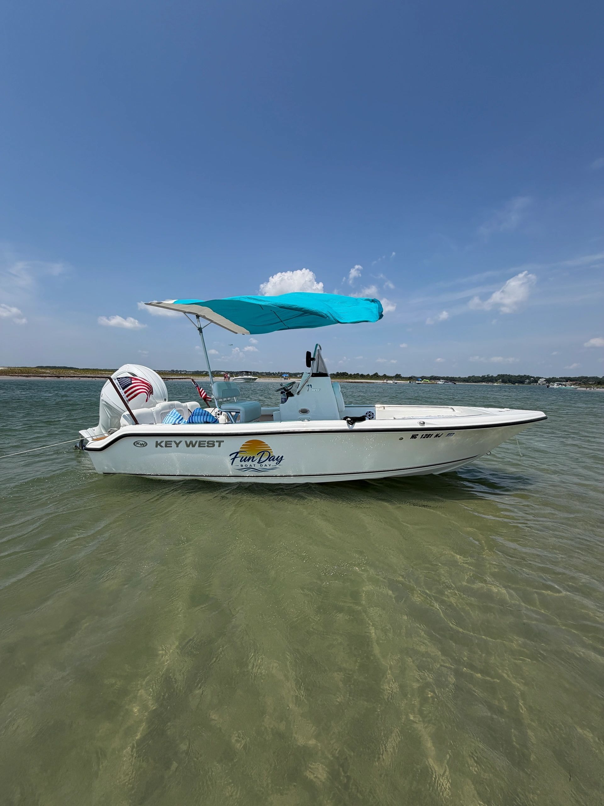 White fishing boat shallow tropical waters